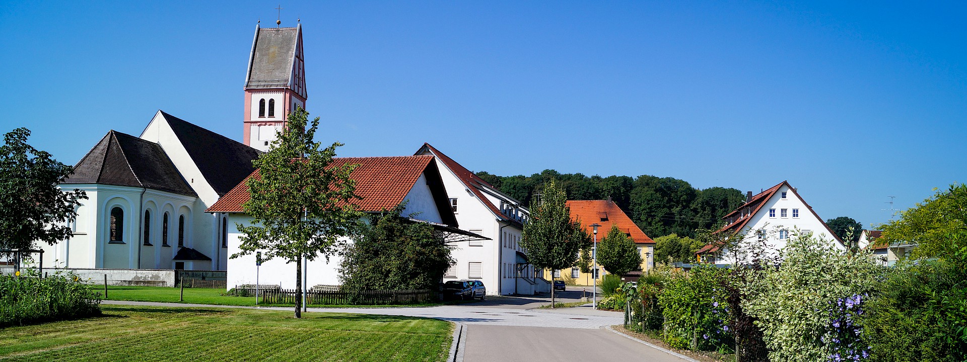 Wohnsiedlung in Berkheim mit Häusern und der Kirche St. Konrad/St. Willebold im Hintergrund